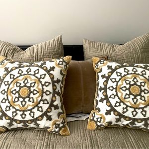 One pair of embroidered/buckle throw pillows.